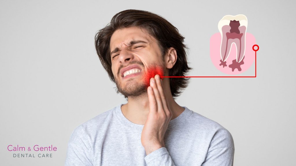 man holding his jaw in pain from tooth infection