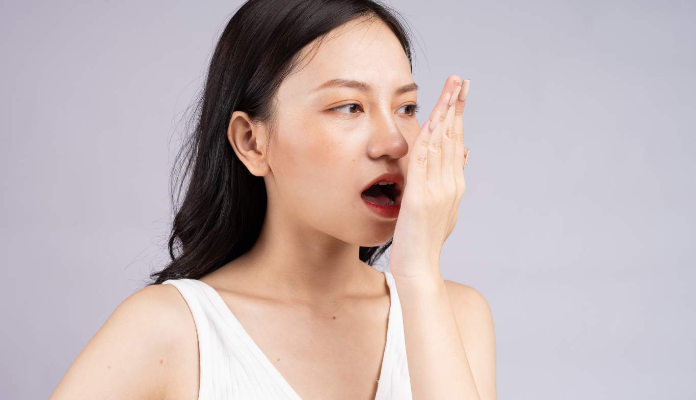 woman smelling her breath