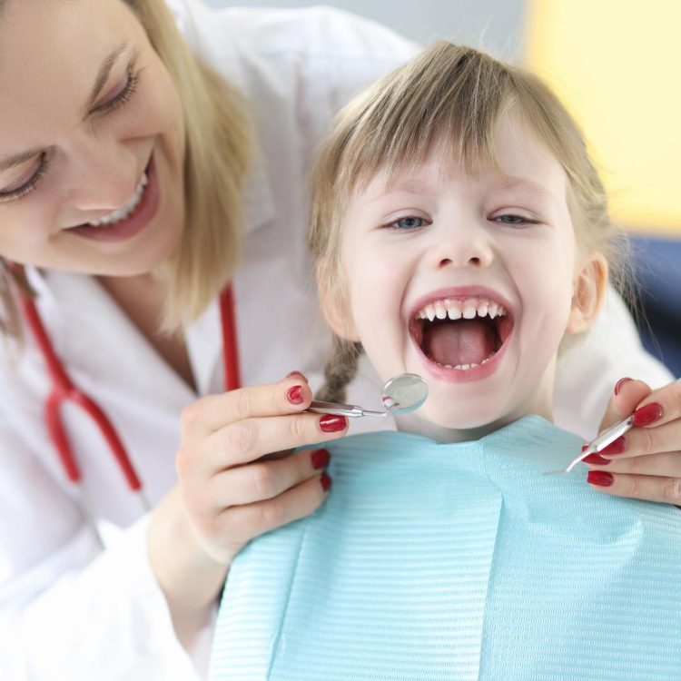 young girl being seen by dentist