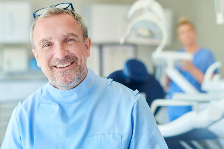 smiling dentist with happy patients