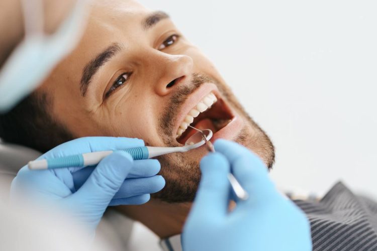 man being seen at dentist